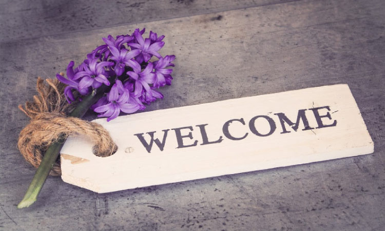 welcome sign with purple flowers