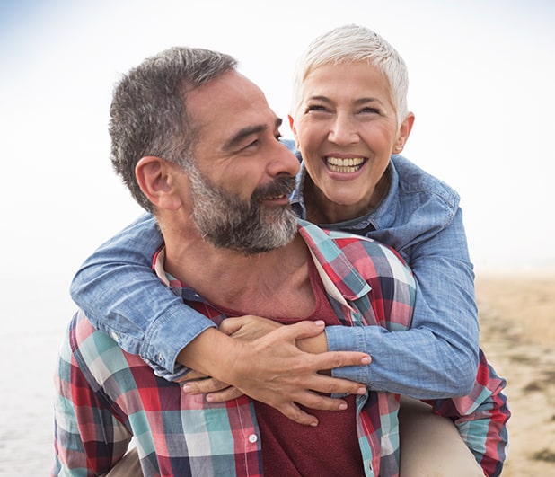 Couple smiling during piggyback ride