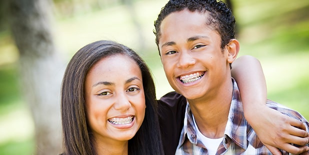 young kids smiling with braces