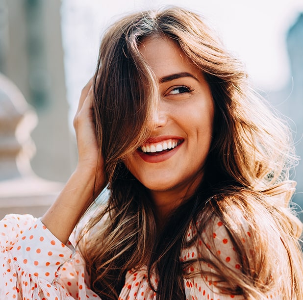 Woman smiling while flipping her hair