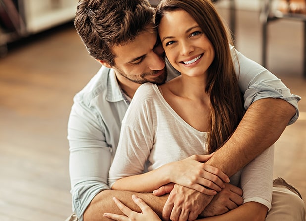 Young couple smiling indoors