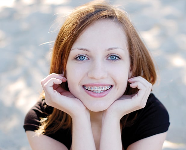 young redhead girl smiling with braces