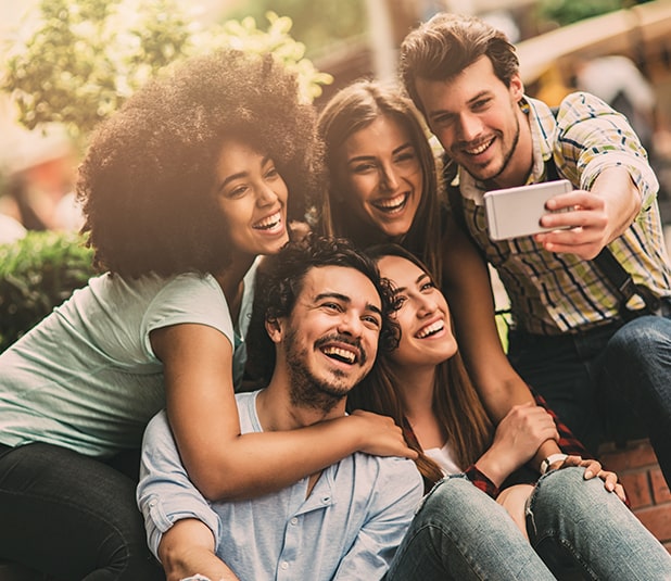 group of friends smiling while taking a picture