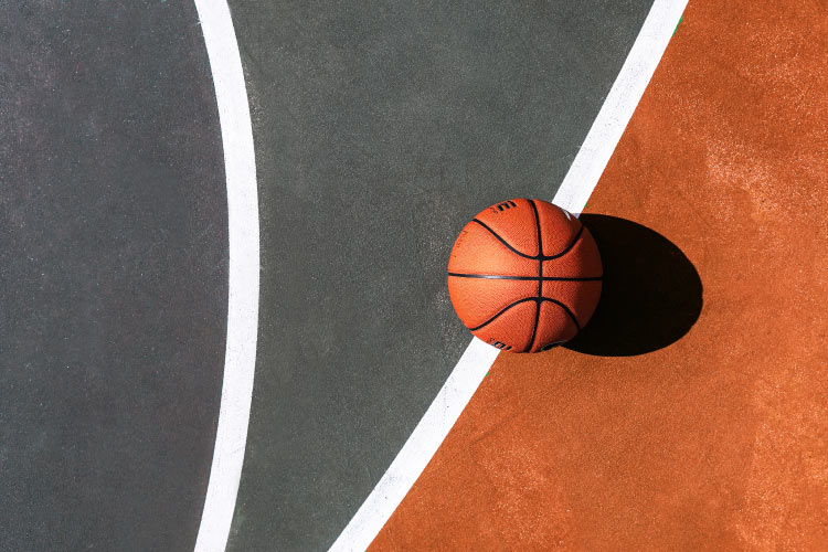 A basketball sits on a basketball court