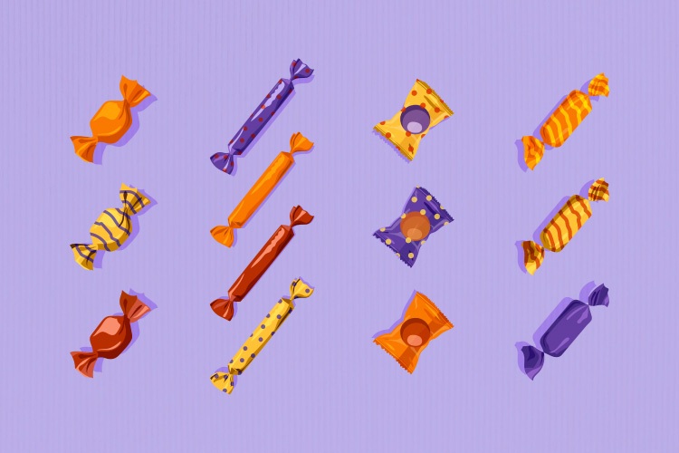 Various candy in wrappers against a purple background