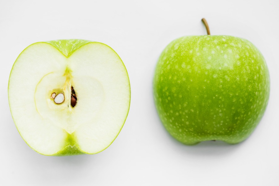 Aerial view of a Granny Smith green apple sliced in half for a St. Patrick's Day treat