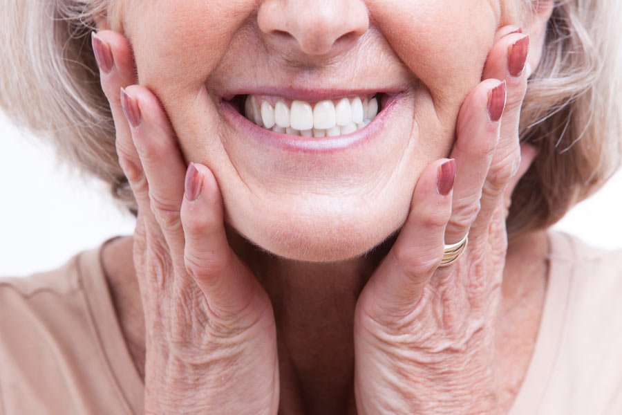 Close up smile of a mature woman and her dental veneers.