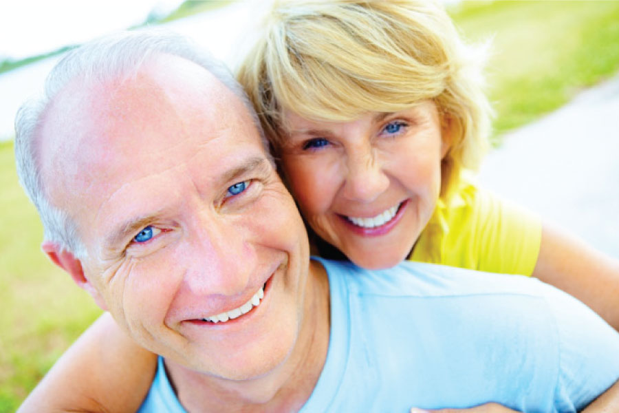 Smiling older couple with white smiles.